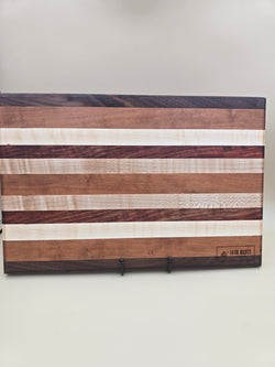 Wooden Cutting board featuring padauk cherry maple and walnut, made by Lathe Nights Woodworking