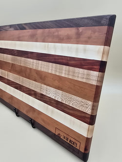 Wooden Cutting board featuring padauk cherry maple and walnut, made by Lathe Nights Woodworking