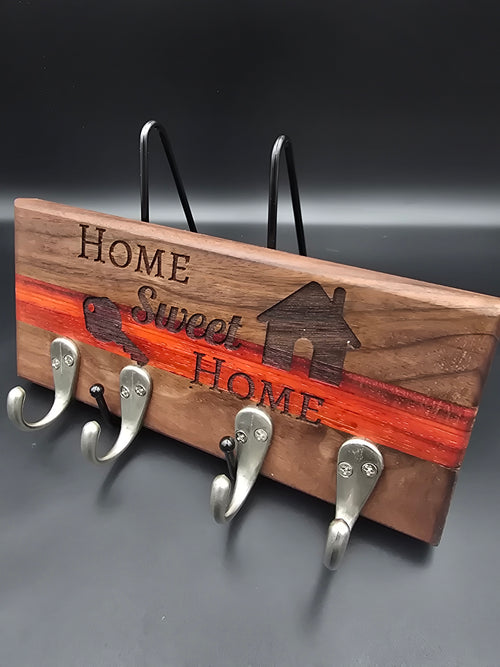 Key Hanger made of walnut and padauk hardwoods, laser engraved with "Home Sweet Home" and features silver hooks, made by lathe nights woodworking