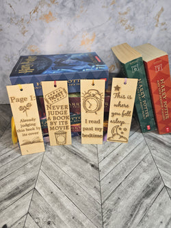 A collection of 4 laser engraved wooden bookmarks with colorful tassels that measure 6" x 2", standard bookmark size. Bookmarks read Page 1 Already Judging this book by its cover. Never Judge a Book by it's movie. I read past my bedtime. This is where you fell asleep. 