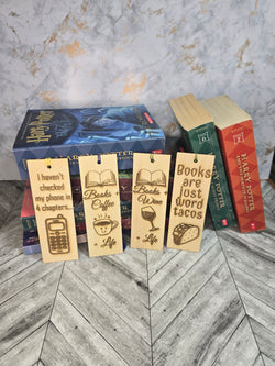 A collection of 4 laser engraved wooden bookmarks with colorful tassels that measure 6" x 2", standard bookmark size. Features laser engraved quotes like 'I haven't checked my phone in 4 chapters' and 'Books plus coffee equals life' and 'books plus wine equals life' and 'books are just word tacos'. 
