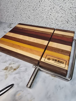 hand crafted wooden cheese board made from walnut, maple, red heart, bolivian rosewood, mahogany, cherry, and yellow heart, built in silver cheese slicing handle perfect for cheese, charcuterie, and appetizers.
