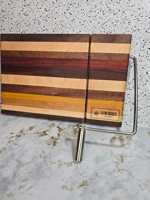 hand crafted wooden cheese board made from walnut, maple, red heart, bolivian rosewood, mahogany, cherry, and yellow heart, built in silver cheese slicing handle perfect for cheese, charcuterie, and appetizers.