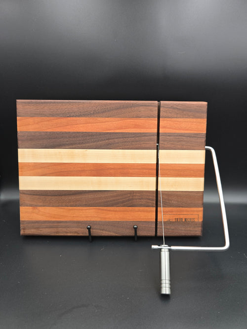 hand crafted wooden cheese board made from walnut, maple, and cherry, built in silver cheese slicer handle perfect for cheese, charcuterie, and appetizers.