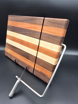 hand crafted wooden cheese board made from walnut, maple, and cherry, built in silver cheese slicer handle perfect for cheese, charcuterie, and appetizers.