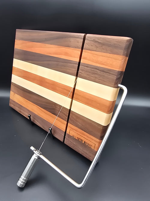 hand crafted wooden cheese board made from walnut, maple, and cherry, built in silver cheese slicer handle perfect for cheese, charcuterie, and appetizers.