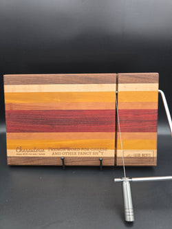modern handcrafted wooden cheese board made from walnut, maple, rosewood, red heart and yellow heart, built in silver cheese slicer, perfect for charcuterie, cheese, and appetizers. Laser engraved with the phrase "charcuterie french word for cheese and other fancy shit"