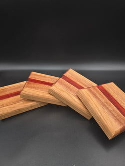 Set of 4 handcrafted wooden coasters, featuring cherry mahogany and padauk hardwoods.