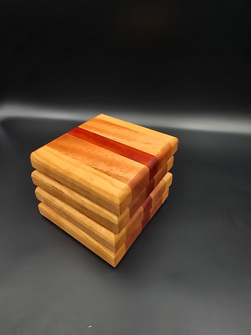 Set of 4 handcrafted wooden coasters, featuring cherry mahogany and padauk hardwoods.