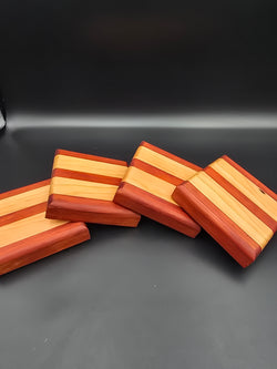 Set of 4 square wooden coasters, made using padauk and cherry natural hardwoods. Features non-slip rubber feet